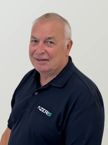 Older man in navy polo shirt smiling